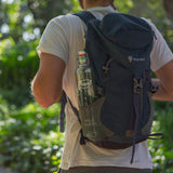 Photo of the Philos wild glass bottle being carried in a backpack on a hike.